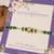 Green beaded floral charm rakhi with roli chawal capsules