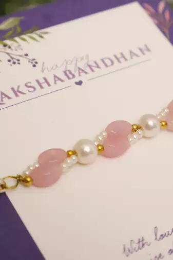 Pink pearl beaded designer rakhi with roli chawal capsules