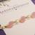 Pink pearl beaded designer rakhi with roli chawal capsules