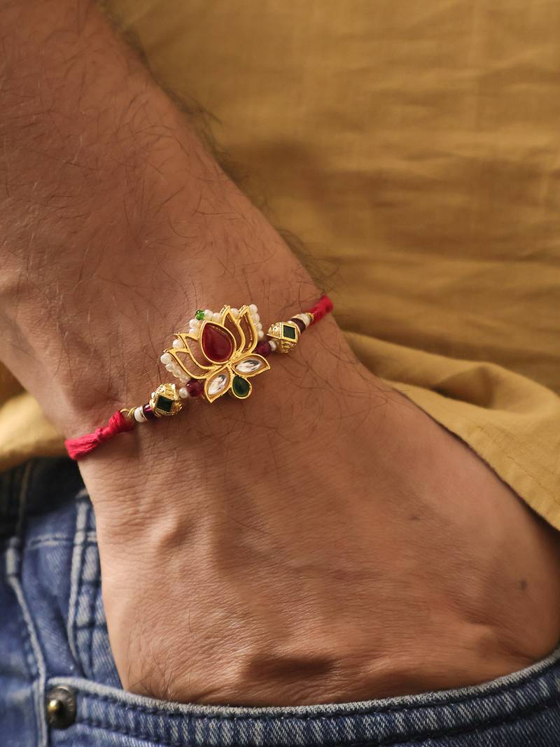 Lotus kundan stone designer rakhi with roli chawal capsules