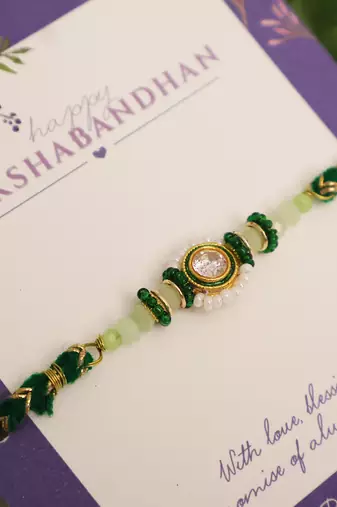 Green beaded floral charm rakhi with roli chawal capsules
