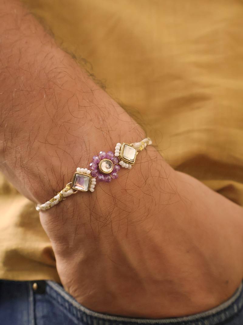Purple floral pearl stone rakhi with roli chawal capsules