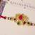 Lotus kundan stone designer rakhi with roli chawal capsules
