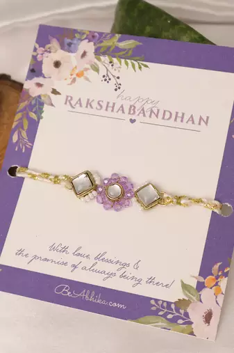 Purple floral pearl stone rakhi with roli chawal capsules