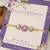 Purple floral pearl stone rakhi with roli chawal capsules