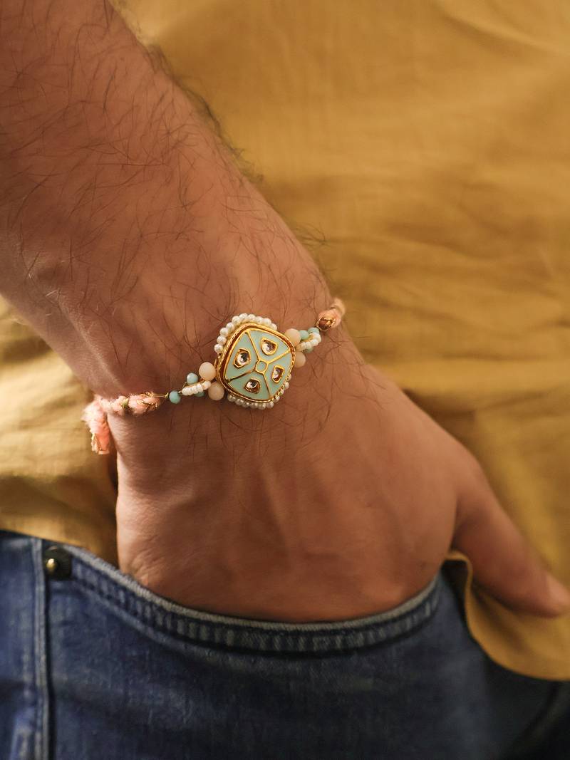 Pastel kundan pearl charm rakhi with roli chawal capsules