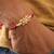 Kundan floral pearl red rakhi with roli chawal capsules