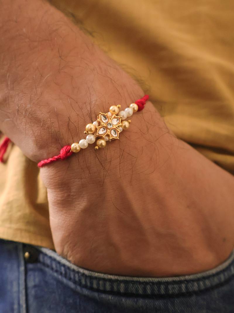 Kundan floral pearl red rakhi with roli chawal capsules