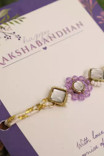 Purple floral pearl stone rakhi with roli chawal capsules