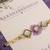 Purple floral pearl stone rakhi with roli chawal capsules