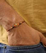 Amber diamond beaded thread rakhi with roli chawal capsules