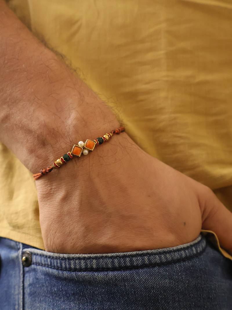 Amber diamond beaded thread rakhi with roli chawal capsules