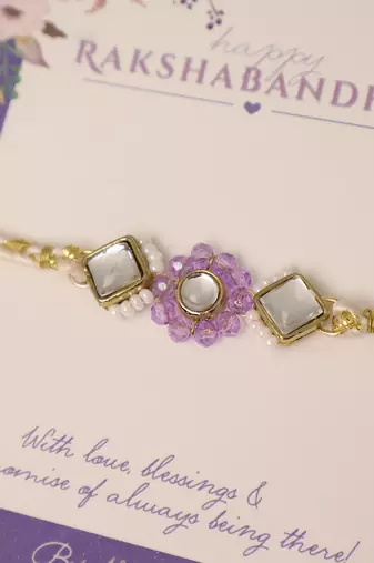 Purple floral pearl stone rakhi with roli chawal capsules
