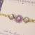 Purple floral pearl stone rakhi with roli chawal capsules