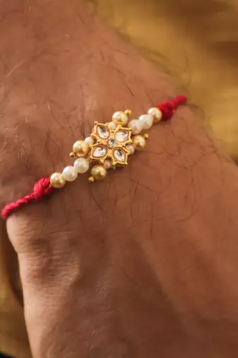 Kundan floral pearl red rakhi with roli chawal capsules