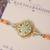 Pastel kundan pearl charm rakhi with roli chawal capsules