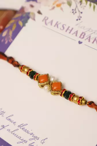Amber diamond beaded thread rakhi with roli chawal capsules