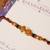 Amber diamond beaded thread rakhi with roli chawal capsules