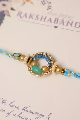 Sky blue crystal halo rakhi with roli chawal capsules