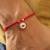 Red evil eye protection rakhi with roli chawal capsules
