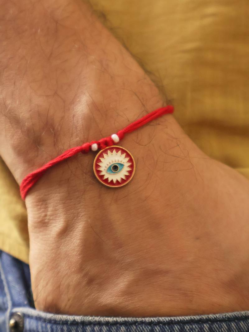 Red evil eye protection rakhi with roli chawal capsules