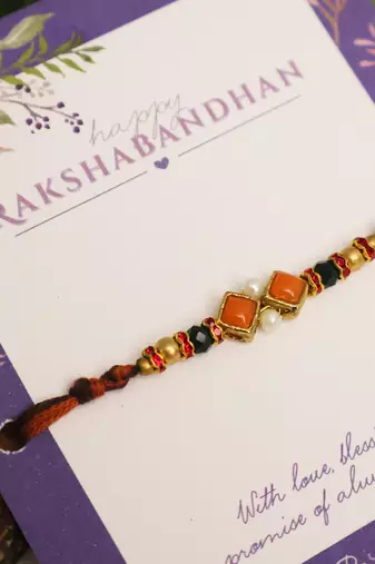 Amber diamond beaded thread rakhi with roli chawal capsules