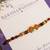 Amber diamond beaded thread rakhi with roli chawal capsules