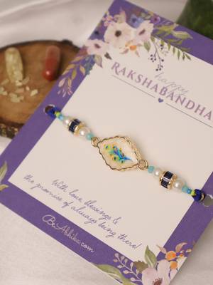 Blue peacock pearl charm rakhi with roli chawal capsules 2