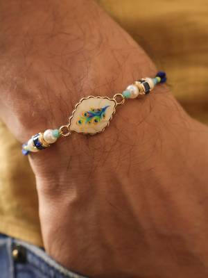 Blue peacock pearl charm rakhi with roli chawal capsules 3