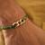 Golden chain green thread rakhi with roli chawal capsules