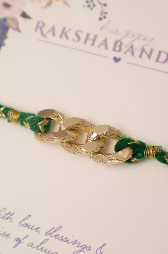 Golden chain green thread rakhi with roli chawal capsules