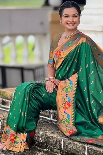 Green silk blend saree with peacock motif zari border