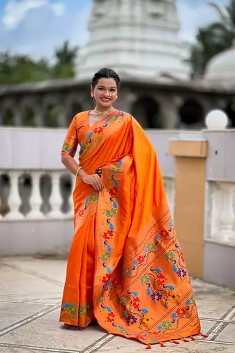 Orange silk blend saree with peacock motif zari border