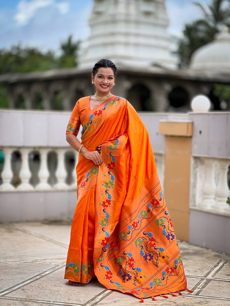Orange silk blend saree with peacock motif zari border
