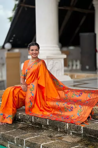 Orange silk blend saree with peacock motif zari border