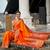 Orange silk blend saree with peacock motif zari border