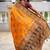 Festive mustard banarasi silk blend saree with colorful meenakari border