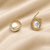 Pearl stud earrings, gold-toned round halo with cz stones, elegant tops