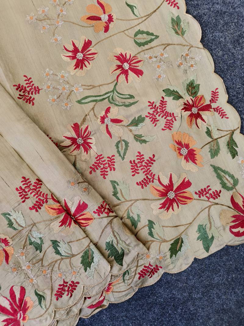 Cream matka silk saree with heavy floral embroidery border with running blouse