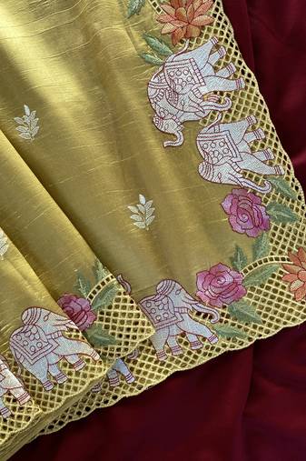 Yellow color embrodied elephant design panel with cutwork and hole work silk blend saree