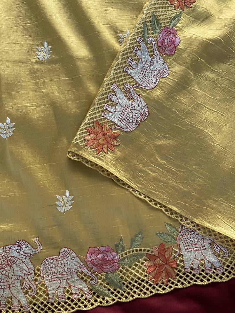 Yellow color embrodied elephant design panel with cutwork and hole work silk blend saree