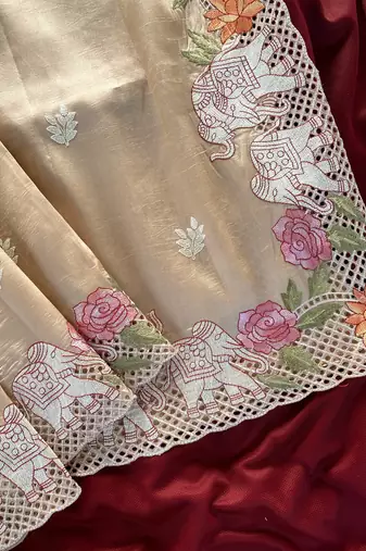 Beige color embrodied elephant design panel with cutwork and hole work viscose silk blend saree