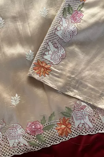 Beige color embrodied elephant design panel with cutwork and hole work viscose silk blend saree