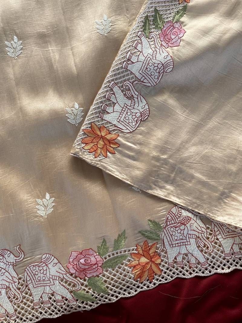 Beige color embrodied elephant design panel with cutwork and hole work viscose silk blend saree