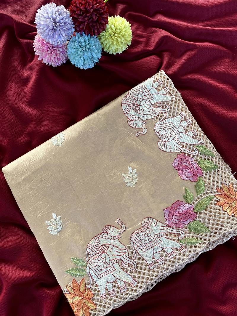Beige color embrodied elephant design panel with cutwork and hole work viscose silk blend saree