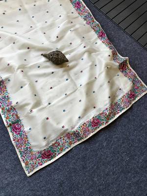 White tissue viscose saree features a heavy floral embroidered border and all-over buttis 1