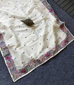 White tissue viscose saree features a heavy floral embroidered border and all-over buttis