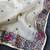 White tissue viscose saree features a heavy floral embroidered border and all-over buttis