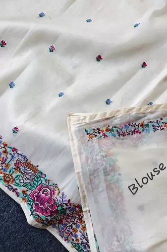 White tissue viscose saree features a heavy floral embroidered border and all-over buttis