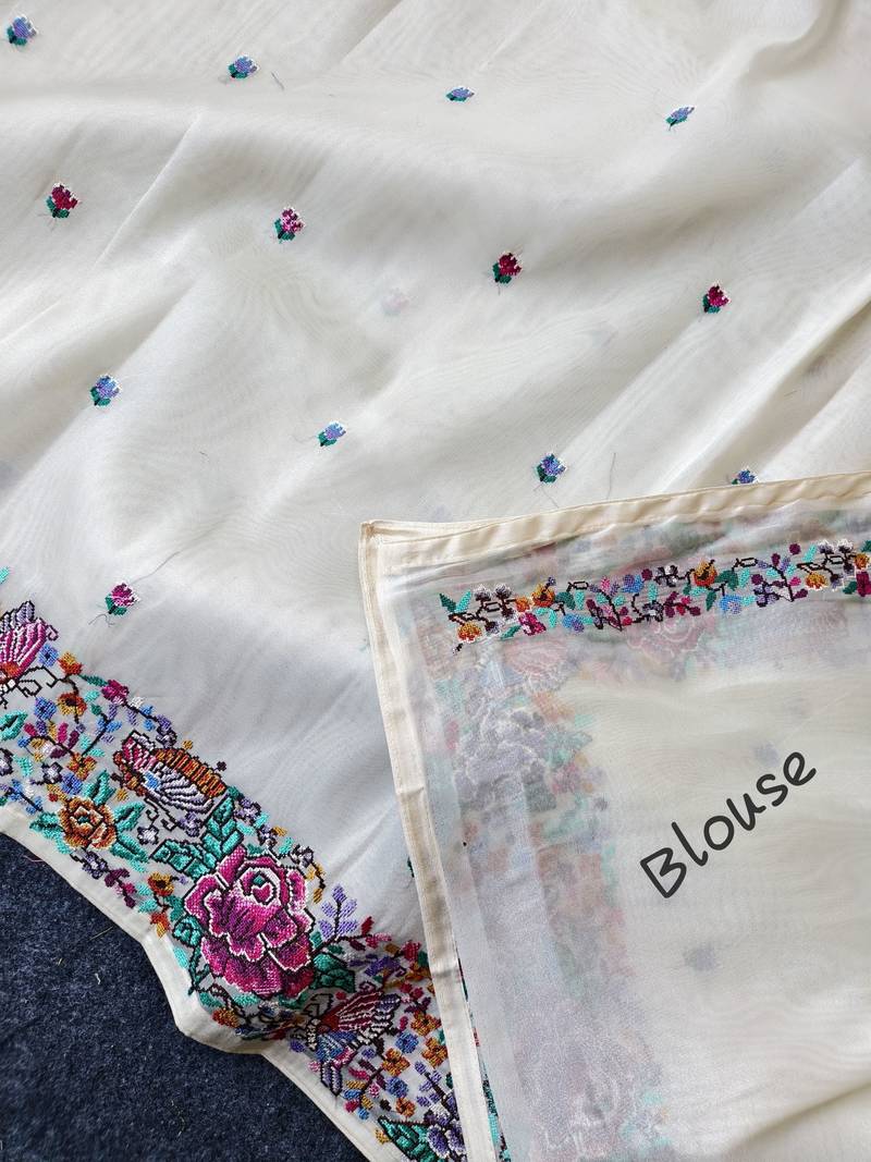 White tissue viscose saree features a heavy floral embroidered border and all-over buttis